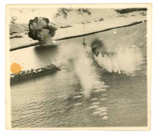 Aerial photograph of a strafing run on shipping