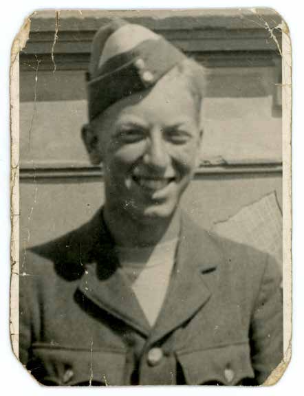Victor Fenn in RAF uniform and cap, smiling for a portrait